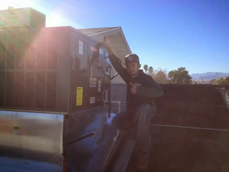 HVAC technician performing Air Duct Repair on a rooftop unit in Alta Sierra